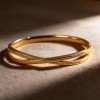 Stainless Steel Gold-Colored Bangle with Open Hollow Design